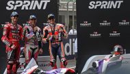 First placed Prima Pramac Racing's Spanish rider Jorge Martin (C), second placed Ducati Lenovo Team's Italian rider Francesco Bagnaia (L) and third placed Repsol Honda's Spanish rider Marc Marquez pose on the podium at the end of the sprint race of the Indian MotoGP Grand Prix. (Photo by Money Sharma/ AFP)