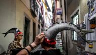 Women are pictured wearing a “sardine hat” at Alfama neighborhood in Lisbon, on June 12, 2023. (Photo by Patricia De Melo Moreira / AFP)