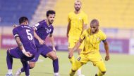 Al Gharafa's Yacine Brahimi (right) controls the ball.