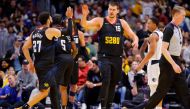 Jamal Murray #27 of the Denver Nuggets high fives Nikola Jokic #15 of the Denver Nuggets during the fourth quarter against the Dallas Mavericks. Photo by C. Morgan Engel/Getty Images/AFP 