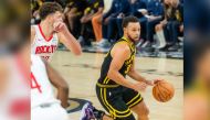 Stephen Curry (R) of Golden State Warriors breaks through during the 2023-2024 NBA regular season match between the Golden State Warriors and the Houston Rockets in San Francisco, the United States, on Nov. 20, 2023. (Photo by Dong Xudong/Xinhua)
