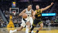 Devin Vassell #24 of the San Antonio Spurs drives against Stephen Curry #30 of the Golden State Warriors during the first quarter of the NBA In-Season Tournament game. Thearon W. Henderson/Getty Images/AFP 