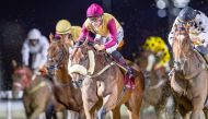 Jockey Soufiane Saadi (centre) guides Ernest Aldrich to Brooq Cup victory during the 11th Al Rayyan Race Meeting. Pic: Juhaim/QREC