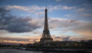 This photograph taken on December 5, 2023, shows a general view of the Eiffel tower along the Seine River in Paris. (Photo by MIGUEL MEDINA / AFP)
