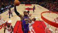 Lebron James 23 of the Los Angeles Lakers dunks over DeMar DeRozan of the Chicago Bulls during the first half at the United Center on December 20, 2023 in Chicago, Illinois. (Photo by Michael Reaves/Getty Images/AFP)