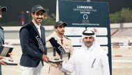 Longines Hathab Qatar Equestrian Tour Organising Committee Vice Chairman Ali bin Youssef Al Rumaihi presents the Medium Tour winner’s trophy to Saeed Hamad Jumaa. 