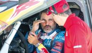 Prodrive’s Qatari driver Nasser Al Attiyah talks with a technician ahead of the Dakar 2024 in Al Ula, Saudi Arabia. AFP