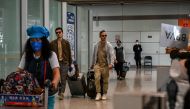 File photo of Passengers walk through the arrivals hall for international flights at the Capital International Airport in Beijing on March 14, 2023. Photo by Jade GAO / AFP

