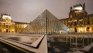 This photograph shows the snow-covered floor at the Louvre museum in Paris, with the Louvre Pyramid, designed by Chinese-American architect Ieoh Ming Pei, seen in the background, on January 18, 2024. (Photo by Dimitar DILKOFF / AFP)