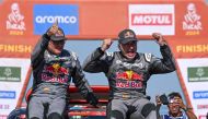 eam Audi Sport's Spanish driver Carlos Sainz (R) and his Spanish co-driver Lucas Cruzof (L) celebrate on their car after crossing the finish line of stage 12 of the Dakar rally 2024 from Yanbu to Yanbu, on January 19, 2024, at the end. Photo by PATRICK HERTZOG / AFP