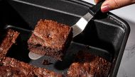 A metal pan and an offset spatula are brownie tools of engagement. (Scott Suchman for The Washington Post/food styling by Lisa Cherkasky for The Washington Post)