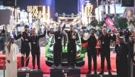 QMMF President Abdulrahman Al Mannai (second right), Executive Director Amro Al Hamad (left) and Secretary General Abdul Razzaq Al Kuwari pose with the podium winners at the conclusion of the Qatar International Rally at Lusail Boulevard yesterday.