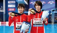 Gold medallists China’s Chen Yuxi and Quan Hongchan pose during the medal ceremony yesterday. AFP