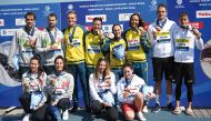 Silver-medallists team Italy, gold-medallists team Australia and bronze-medallists team Hungary pose on the podium with their medals after the final of the mixed 4X1500m relay open water swimming event. PICS: AFP