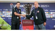 Jordan coach Hussein Ammouta and Qatar coach Marquez Lopez shake hands following a press conference, yesterday.