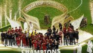 Qatar's players celebrate with the Qatar 2023 AFC Asian Cup trophy during the podium ceremony after the final football match between Jordan and Qatar at the Lusail Stadium in Lusail, north of Doha on February 10, 2024. (Photo by KARIM JAAFAR / AFP)
