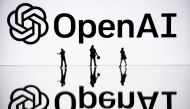 (Files) This illustration photograph taken on October 30, 2023, in Mulhouse, eastern France, shows figurines next to a screen displaying a logo of OpenAI. (Photo by Sebastien Bozon / AFP)