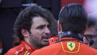 Ferrari's Spanish driver Carlos Sainz Jr talks to team members in the garage after the first practice session of the Saudi Arabian Formula One Grand Prix at the Jeddah Corniche Circuit in Jeddah on March 7, 2024. (Photo by Giuseppe CACACE / AFP)