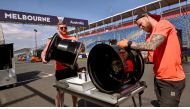 Haas F1 garage technicians John Crawley (R) and Max Cooper (L) prepare tyre rims at the Albert Park circuit as Formula One teams prepare for the upcoming 2024 Formula One Australian Grand Prix, in Melbourne on March 19, 2024. (Photo by William WEST / AFP) 