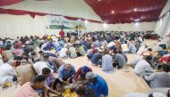 People break their fast at a Ramadan tent in Al Muraikh.