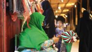 An Emirati woman weaves thread in the Al Talli method, a traditional local weaving technique, during an annual heritage festival in Al Ain. 