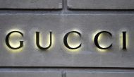 This picture taken on December 19, 2017 shows a logo outside the fashion house and luxury goods Gucci shop on the Avenue Montaigne in Paris, ahead of Christmas. Photo by STEPHANE DE SAKUTIN / AFP