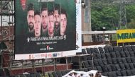 Spectators sit under a plastic sheet in stands during rainfall before the start of the first Twenty20 international cricket match between Pakistan and New Zealand at the Rawalpindi Cricket Stadium in Rawalpindi on April 18, 2024. (Photo by Aamir Qureshi / AFP)