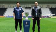 Japan coach Go Oiwa (left) and Uzbekistan coach Timur Kapadze pose with the AFC U23 Cup trophy on the eve of the final in Doha. 