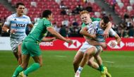 Argentina's Tobias Wade is tackled by Ireland痴 Gavin Mullin during the men's Cup quarter-final match between Argentina and Ireland at the HSBC Rugby Sevens tournament at the National Stadium in Singapore on May 4, 2024. (Photo by Roslan RAHMAN / AFP)