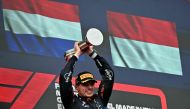 Race winner Red Bull Racing's Dutch driver Max Verstappen holds his trophy on the podium of the Emilia Romagna Formula One Grand Prix at the Autodromo Enzo e Dino Ferrari race track in Imola on May 18, 2024. (Photo by ANDREJ ISAKOVIC / AFP)