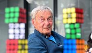 Hungarian inventor Erno Rubik sits next to several Rubik's Cubes during an interview with AFP in Budapest on April 29, 2024. (Photo by Attila Kisbenedek / AFP)