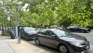 An internal-combustion Toyota Camry blocks a FLO EV charger near Stephanie Doba’s home in Park Slope. MUST CREDIT: Alicia Clanton/Bloomberg