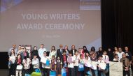 Participants and officials at the awards ceremony of the Young Writers event.