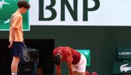 Serbia's Novak Djokovic reacts after falling on the court during his men's singles round of sixteen match against Argentina's Francisco Cerundolo on Court Philippe-Chatrier on day nine of the French Open tennis tournament at the Roland Garros Complex in Paris on June 3, 2024. Photo by Emmanuel Dunand / AFP.
 