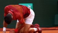 Serbia's Novak Djokovic reacts after falling on the court during his men's singles round of sixteen match against Argentina's Francisco Cerundolo on Court Philippe-Chatrier on day nine of the French Open tennis tournament at the Roland Garros Complex in Paris on June 3, 2024. (Photo by Emmanuel Dunand / AFP)