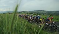 The pack rides during the fifth stage of the 76th edition of the Criterium du Dauphine cycling race, 167km between Amplepuis and Saint-Priest, central France, on June 6, 2024. (Photo by Thomas SAMSON / AFP)