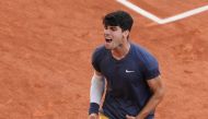 Spain's Carlos Alcaraz celebrates after winning against Germany's Alexander Zverev at the end of their men's singles final match on Court Philippe-Chatrier on day fifteen of the French Open tennis tournament at the Roland Garros Complex in Paris on June 9, 2024. (Photo by Dimitar DILKOFF / AFP)