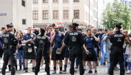 Police face supporters of Scotland's national soccer team wearing kilts as they block the way to the central square Marienplatz after it is too crowded by supporters ahead of the UEFA Euro 2024 Group A football match between Germany and Scotland in Munich on June 14, 2024. (Photo by Michaela STACHE / AFP)