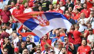 A Serbia supporter waves the national flag prior to the UEFA Euro 2024 Group C football match between Slovenia and Serbia at the Munich Football Arena in Munich on June 20, 2024. (Photo by MIGUEL MEDINA / AFP)