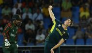 Australia's Pat Cummins bowls as Bangladesh's Litton Das looks on during the ICC men's Twenty20 World Cup 2024 Super Eight cricket match between Australia and Bangladesh at Sir Vivian Richards Stadium in North Sound, Antigua and Barbuda, on June 20, 2024. (Photo by ANDREW CABALLERO-REYNOLDS / AFP)
