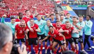 Austria's players pose for a picture as they celebrate at the end of the UEFA Euro 2024 Group D football match between Poland and Austria at the Olympiastadion in Berlin on June 21, 2024. (Photo by Axel Heimken / AFP)