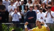 Italy's Lorenzo Musetti celebrates after winning against Australia's Jordan Thompson during their men's singles semi-finals tennis match at the Cinch ATP tennis Championships at Queen's Club in west London on June 22, 2024. (Photo by HENRY NICHOLLS / AFP)
