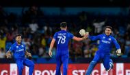 Afghanistan's Nangyal Kharoti (L), Naveen-ul-Haq (C) and Gulbadin Naib (R) celebrates after the dismissal of Australia's Ashton Agar on June 22, 2024. (Photo by Randy Brooks / AFP)