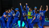 Afghanistan's players celebrate winning their ICC men's Twenty20 World Cup 2024 Super Eight cricket match against Bangladesh at Arnos Vale Stadium in Arnos Vale, Saint Vincent and the Grenadines on June 24, 2024. (Photo by Randy Brooks / AFP)
