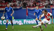 Croatia's midfielder #10 Luka Modric (R) scores his team's first goal during the UEFA Euro 2024 Group B football match between the Croatia and Italy at the Leipzig Stadium in Leipzig on June 24, 2024. (Photo by Christophe Simon / AFP)