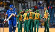 South Africa's players celebrate after Afghanistan's Rahmanullah Gurbaz (L) is run out during the ICC men's Twenty20 World Cup 2024 semi-final cricket match between South Africa and Afghanistan at Brian Lara Cricket Academy in Tarouba, Trinidad and Tobago, on June 26, 2024. (Photo by Chandan Khanna / AFP)