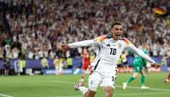 Germany's midfielder #10 Jamal Musiala celebrates scoring his team's second goal during the UEFA Euro 2024 round of 16 football match between Germany and Denmark at the BVB Stadion Dortmund in Dortmund on June 29, 2024. (Photo by KENZO TRIBOUILLARD / AFP)
