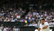 Serbia's Novak Djokovic returns the ball to Britain's Jacob Feamley during their men's singles tennis match on the fourth day of the 2024 Wimbledon Championships at The All England Lawn Tennis and Croquet Club in Wimbledon, southwest London, on July 4, 2024. (Photo by Ben Stansall / AFP) 