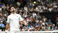 Serbia's Novak Djokovic celebrates winning the second set against Denmark's Holger Rune during their men's singles tennis match on the eighth day of the 2024 Wimbledon Championships at The All England Lawn Tennis and Croquet Club in Wimbledon, southwest London, on July 8, 2024. (Photo by Ben Stansall / AFP) / RESTRICTED TO EDITORIAL USE
