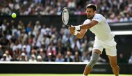 Serbia's Novak Djokovic returning the ball on the fourth day of the 2024 Wimbledon Championships on July 4, 2024. (Photo by Ben Stansall / AFP) 